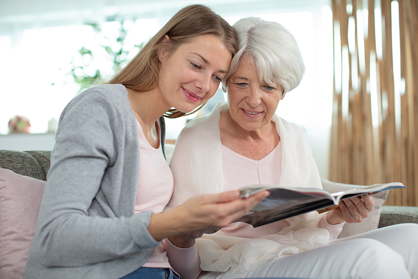 Grandmother and granddaughter looking at a magazine